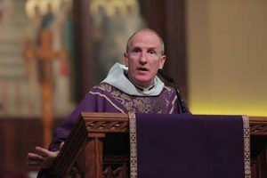 Father McShane delivers a homily at the Rose Hill Church