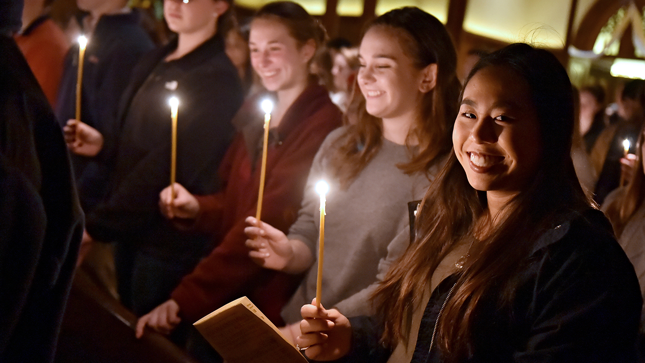 People holding candles at Mass