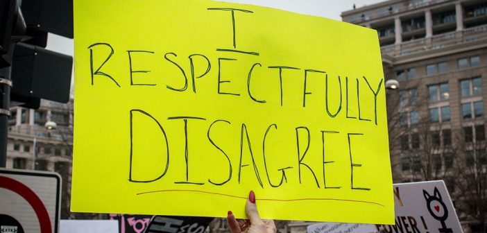 A sign at a recent protest march that says I respectfully disagree