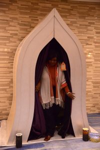 A woman emerges from a "Buddha Booth"