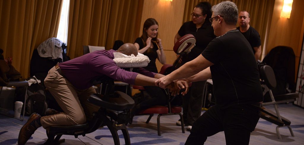 A man gets a massage at a wellness fair on the Rose Hill campus