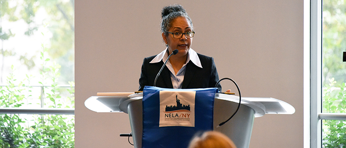 Tanya Hernandez speaking at a podium at Fordham Law