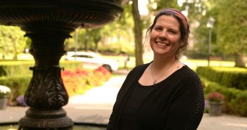 Keri Walsh, Ph.D., associate professor of English, stands next to the fountain on the Rose Hill campus
