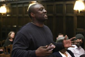 Severin Cornelius, standing up to ask a question in Tognino Hall.