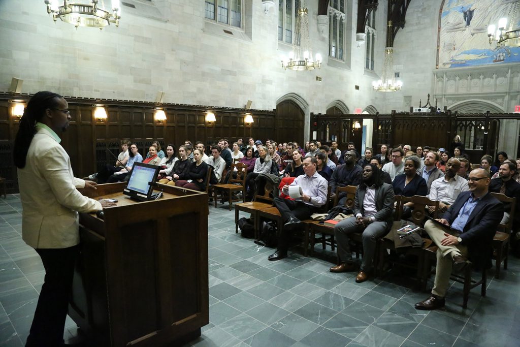 A view from behind Ibram Kendi, Ph.D., as he speaks to a group of people in Tognino Hall.