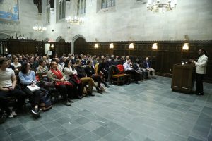 Ibram Kendi, Ph.D., speaks to a group from a podium at Tognino Hall.