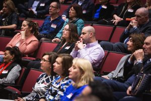 Members of the audience listen intently