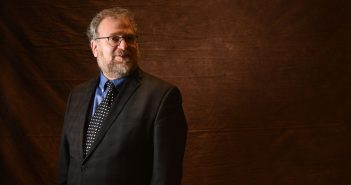 Saul Cornell standing in front of a brown background