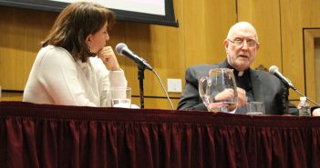 Two panelists talk at lecture