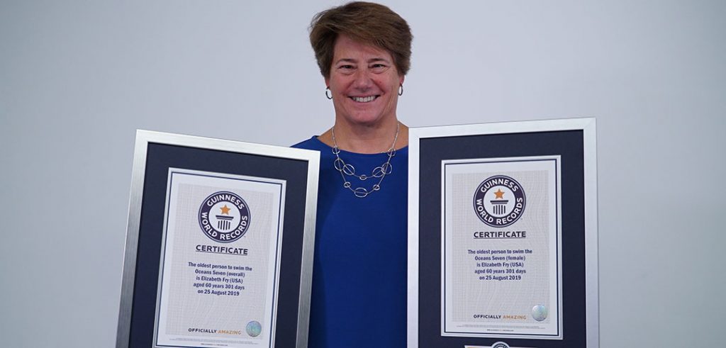 A woman holds two awards