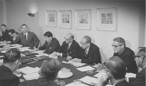 John Feerick sitting at a table alongside then senator Birch Bayh