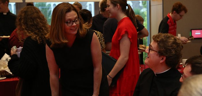 President Tetlow chatting with Jesuit priest at reception