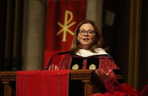 President Tetlow in academic robes speaking on altar