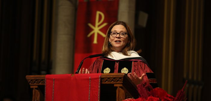 President Tetlow in academic robes speaking on altar