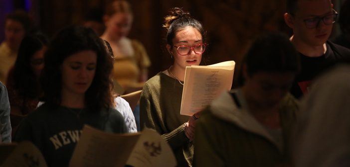 Young woman singing in the pews