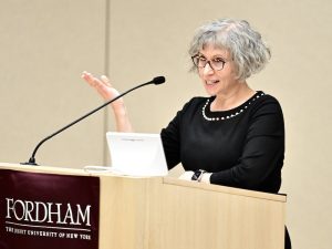 A woman speaks at a podium.