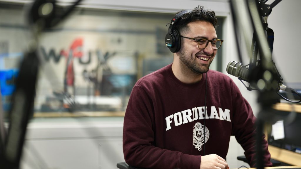 David Escobar speaks into a mic at a WFUV recording booth.