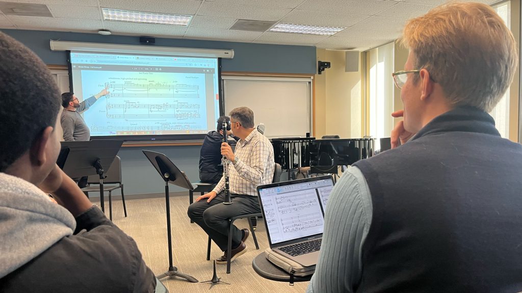 Fordham student composers watch a lecture on music notation