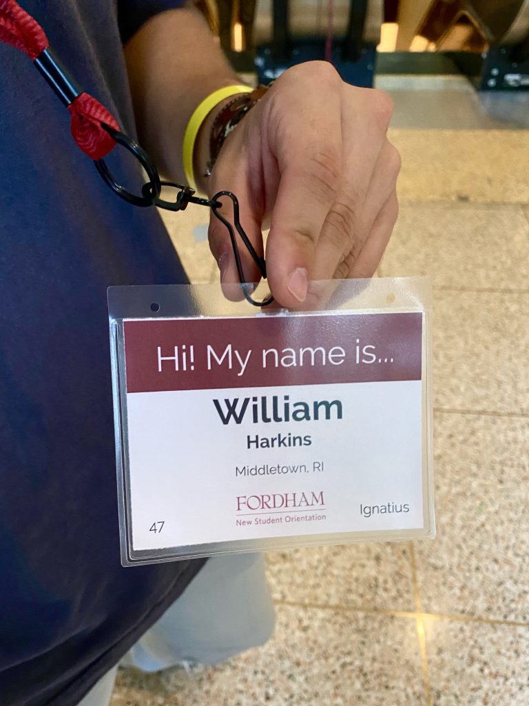 William Harkins holds his orientation badge 