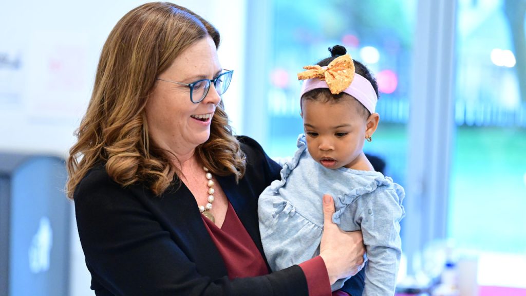 A woman holds a baby