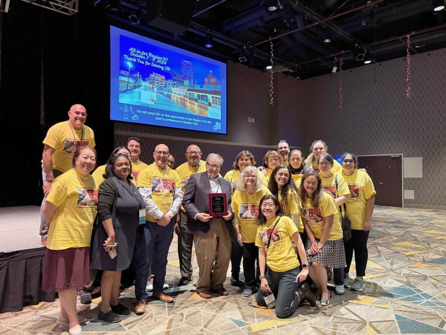 Honoring the ‘Big Daddy’ of International Education Salvatore Longarino holding his lifetime achievement award from NAFSA Region X in Atlantic City this fall, surrounded by his colleagues at Fordham and the many universities where his protégés landed. Photos courtesy of Salvatore Longarino