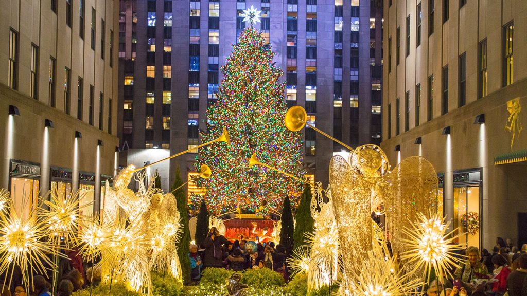 5 Things to Do in NYC | December Rockefeller Christmas Tree with angel sculptures in forefront.