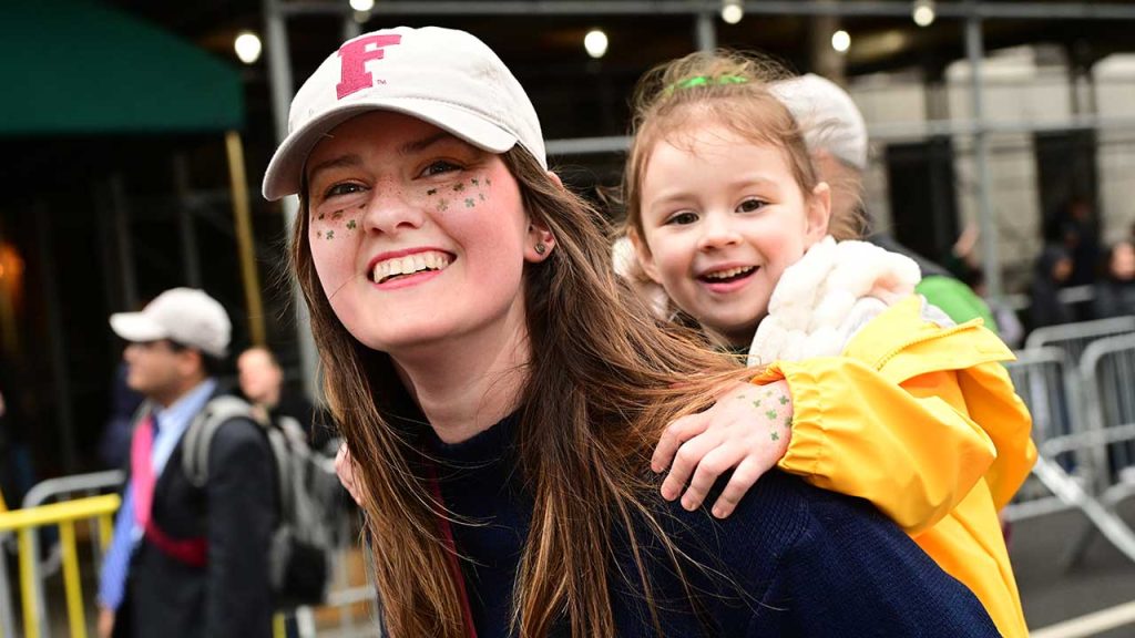 Woman and child smiling in parade