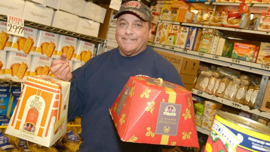 Mike Teitel of Teitel Brothers in the Bronx holds up boxes of Italian bakery goods. 