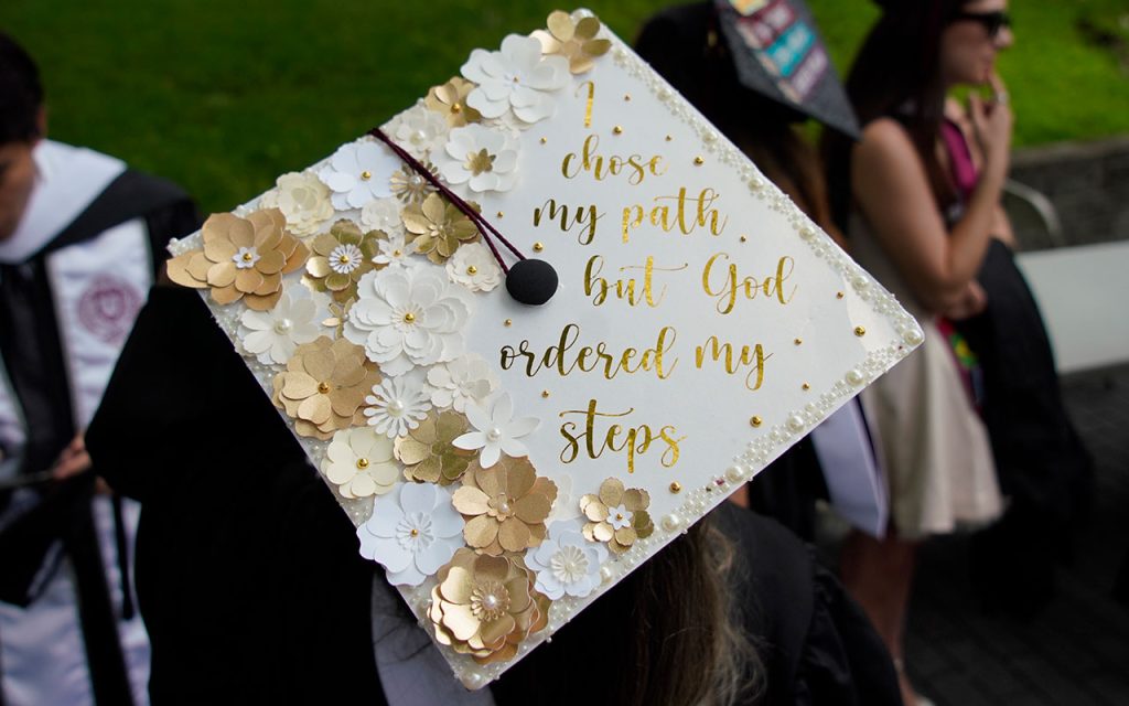 Commencement cap decorated with the message "I chose my path but God ordered my steps"