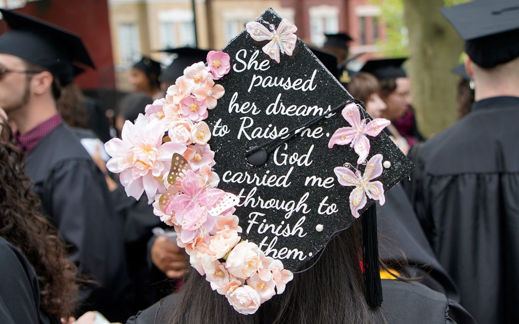 Commencement cap decorated with the message "She paused her dreams to raise me. God carried me through to finish them." 