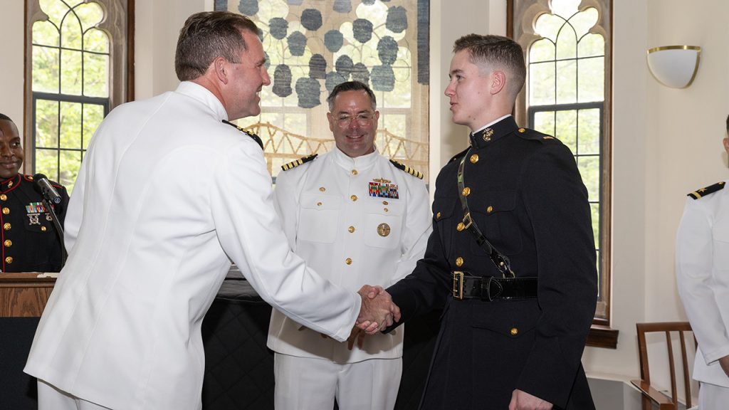 Navy Commander Robert Briggs, Captain Dennis Farrell, and Marine Corps second lieutenant John Barr, Fordham Class of 2025