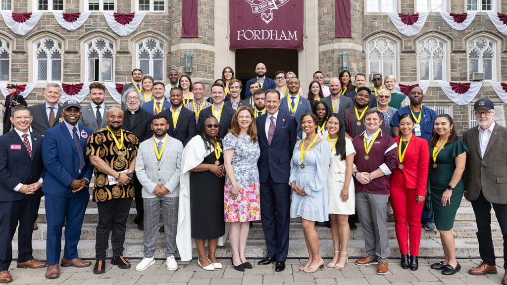 Group photo of Fordham president Tania Tetlow, board chairman Armando Nunez, NYC VeteransJames Hendonand student veterans honored at the 2025 Yellow Ribbon Medallion ceremony.