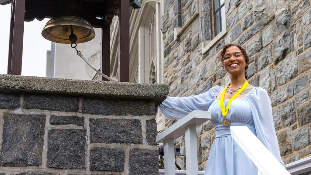 A Yellow Ribbon medallion recipient ringing the Victory Bell