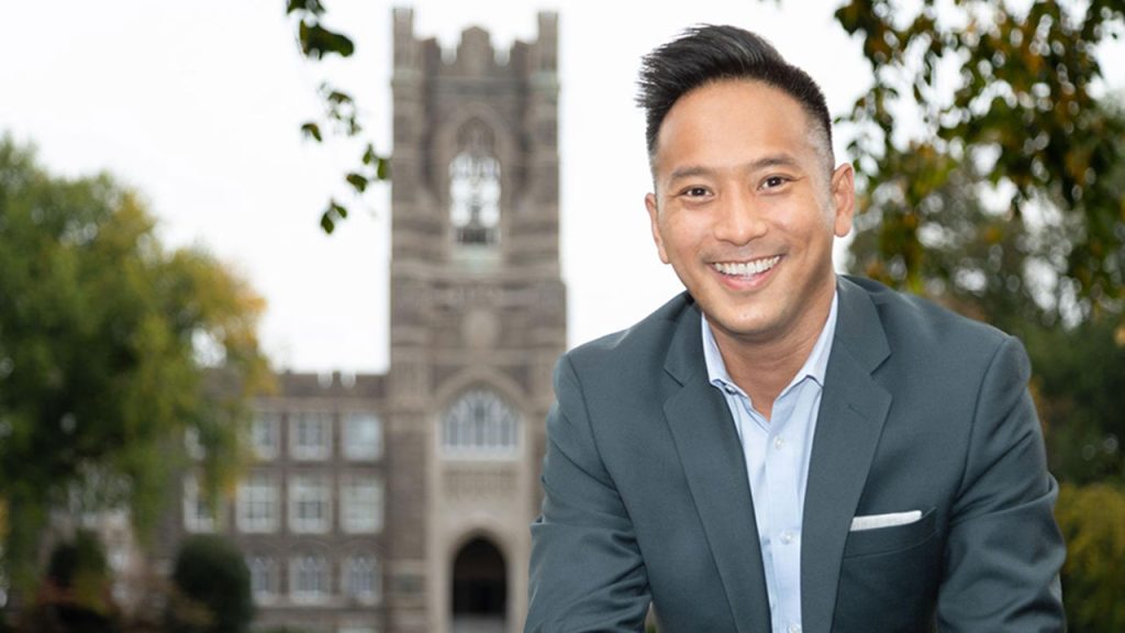 Corbin Wing smiling, Keating in background behind him
