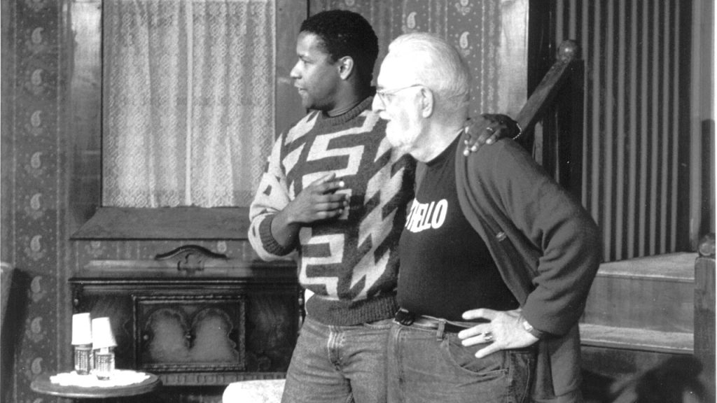 Denzel Washington speaks with Bob Stone at a Fordham event
