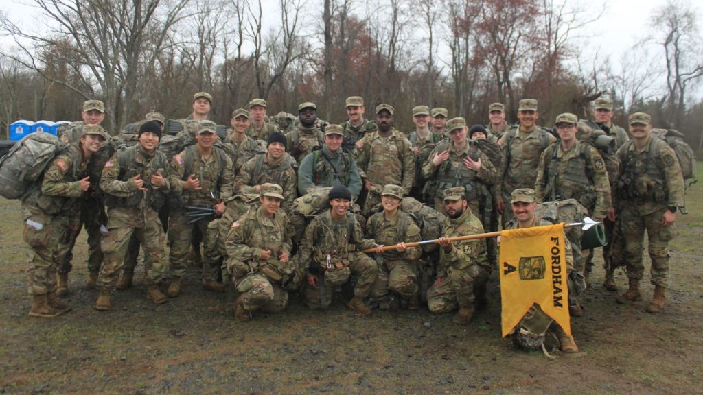 A group of Fordham Army ROTC students pose in camouflage, with Thomas Monroe in the center row.