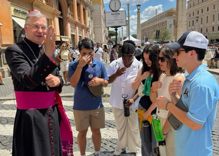 Fordham students receiving a blessing from a Cardinal outside the Vatican.