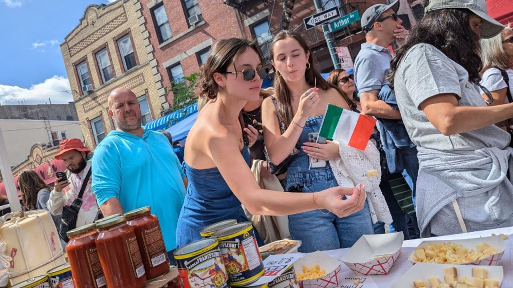 A woman samples cheese at Ferragosto festival on Arthur Avenue in the Bronx. 