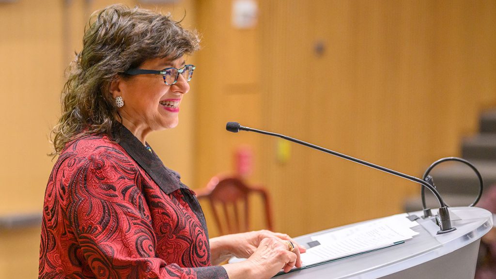 A woman standing at a podium.