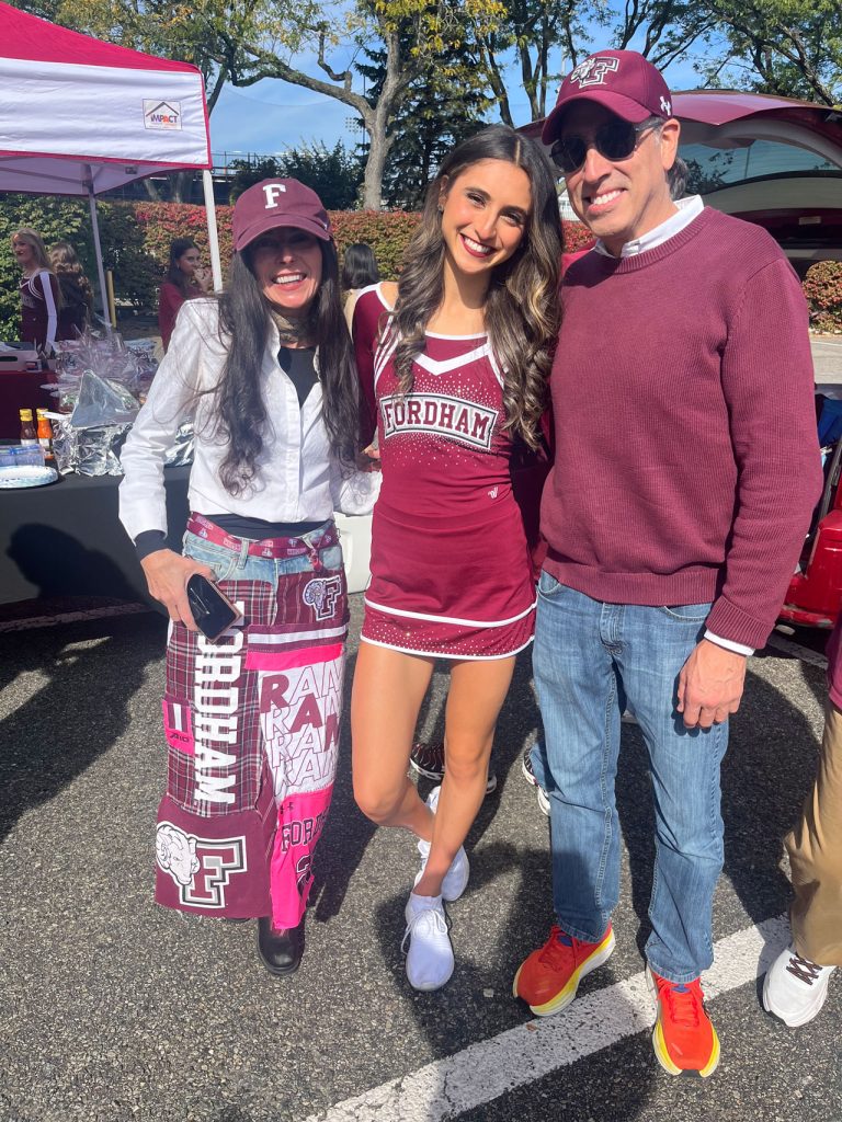 Three people pose in Fordham gear