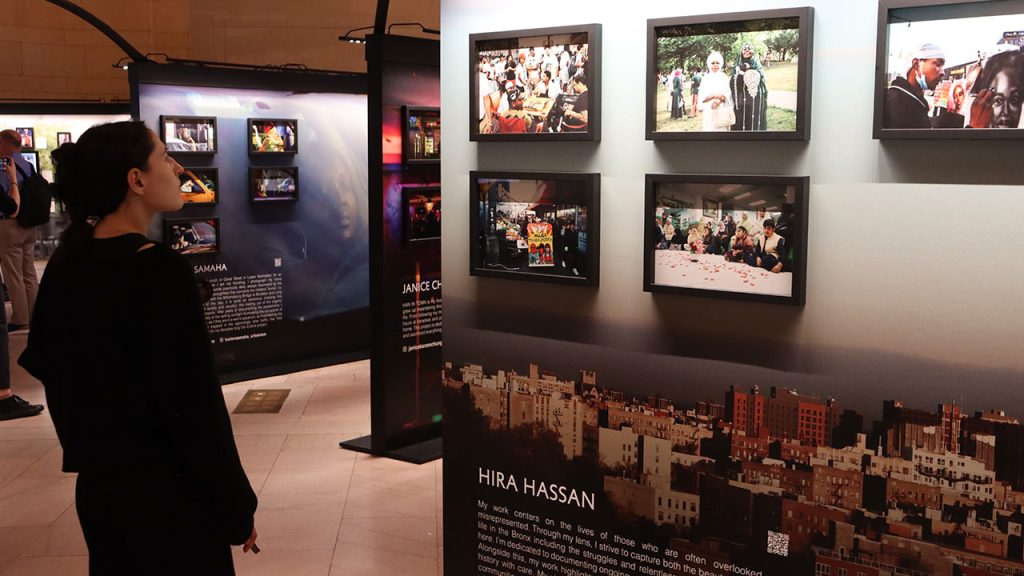 Woman reading sign at Dear New York exhibit Grand Central Terminal