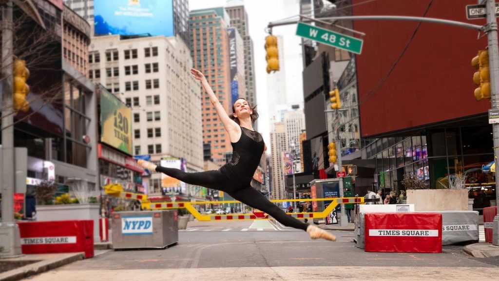 Woman doing a ballet move in Times Square