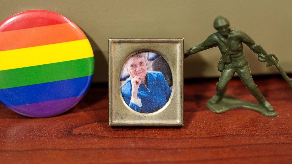 A rainbow photo, framed photo of Anne Mannion, and toy soldier