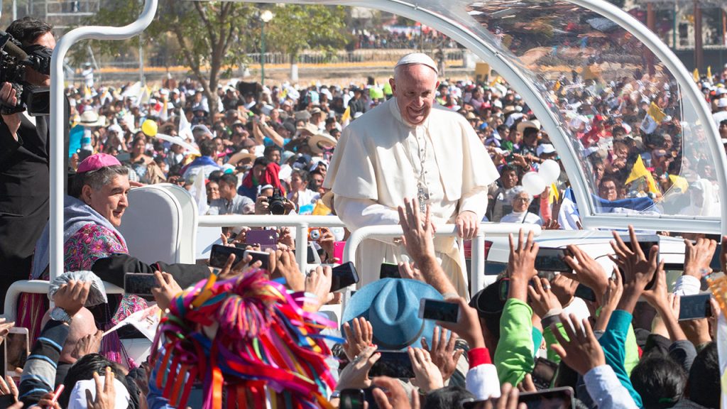 Pope Francis greeting people from his Pope Mobile
