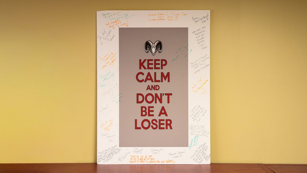 A poster that says "Keep calm and don't be a loser"